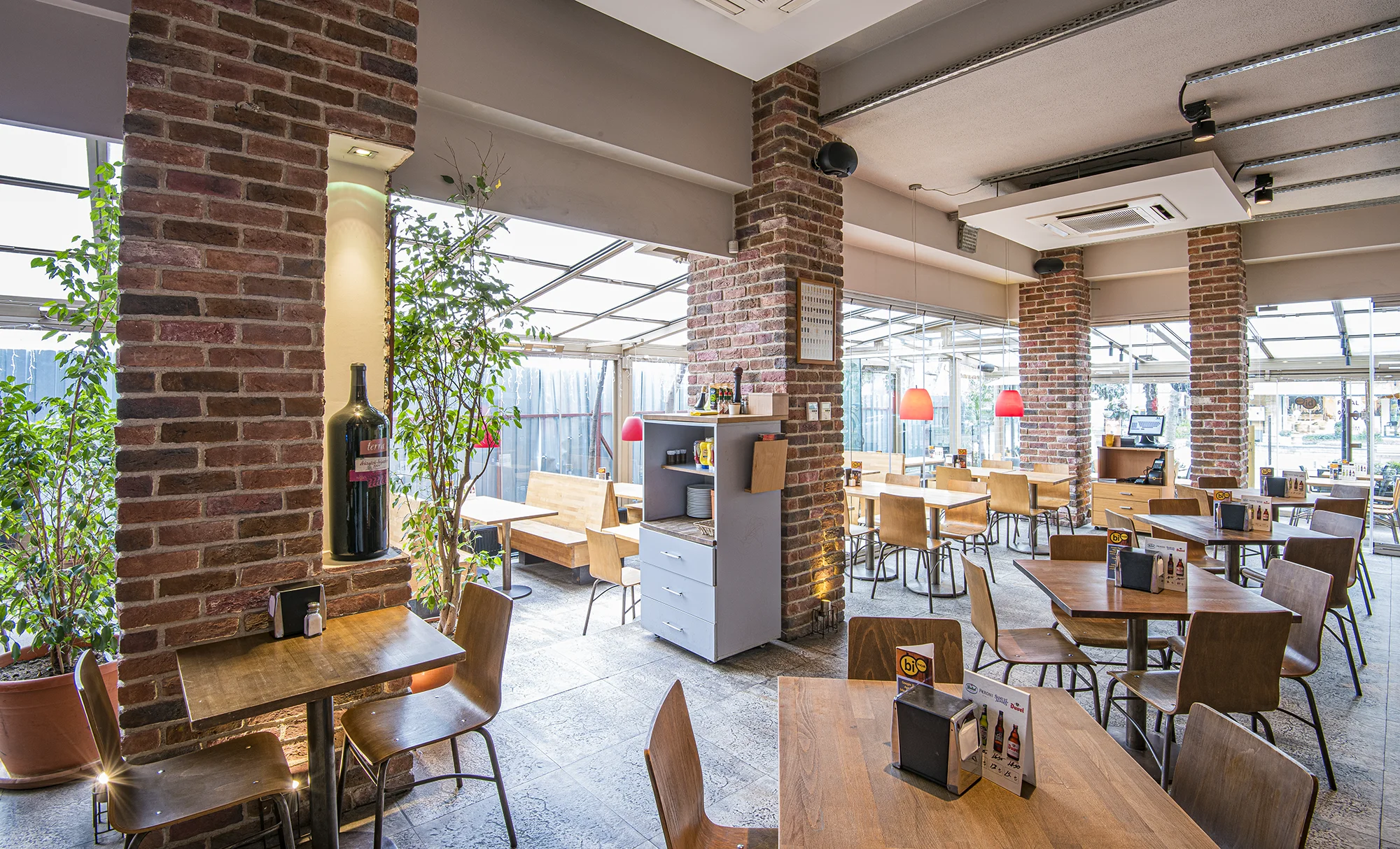 A light-well cafe with red brick walls