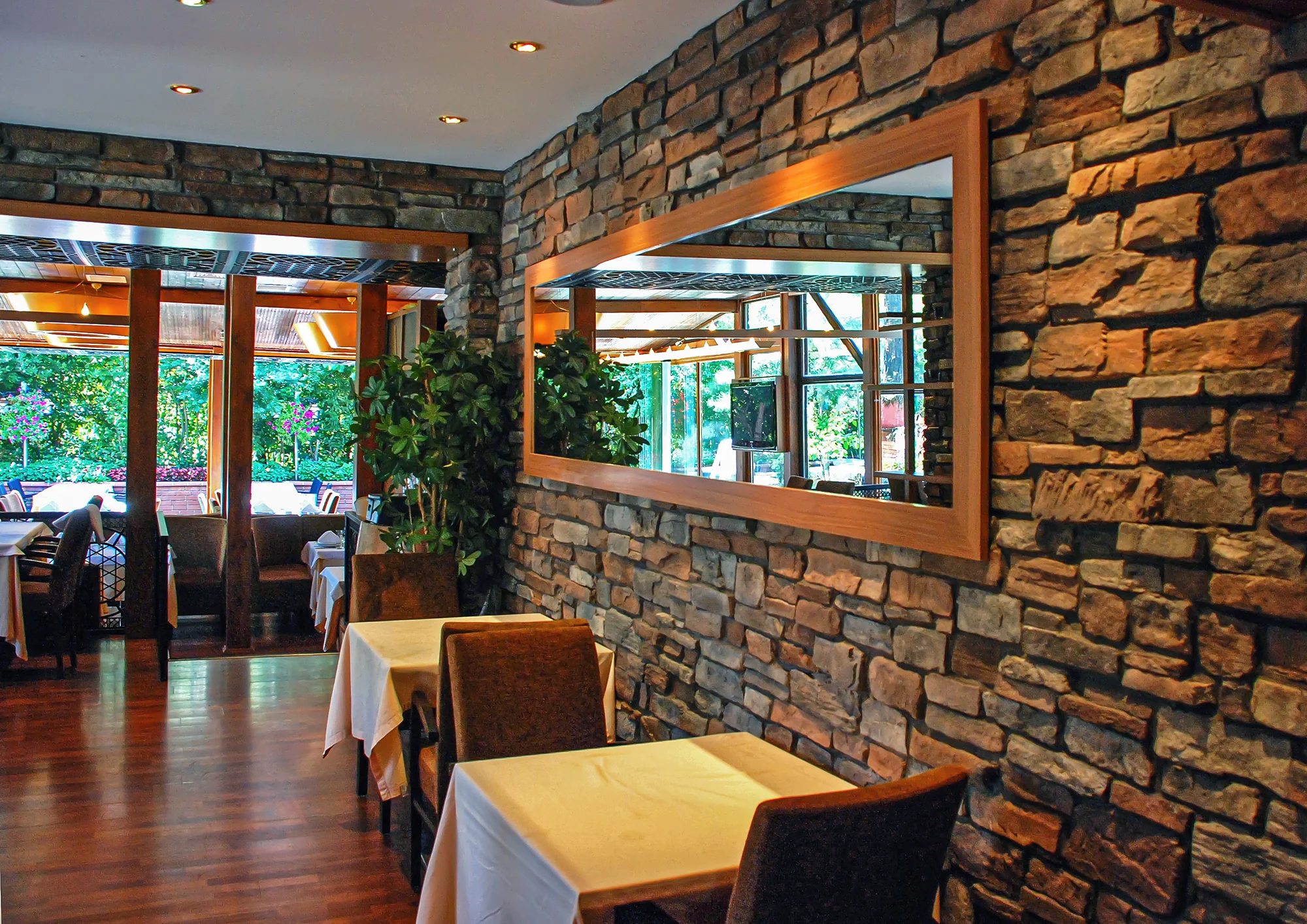 Mirror on a stone wall in a cozy restaurant
