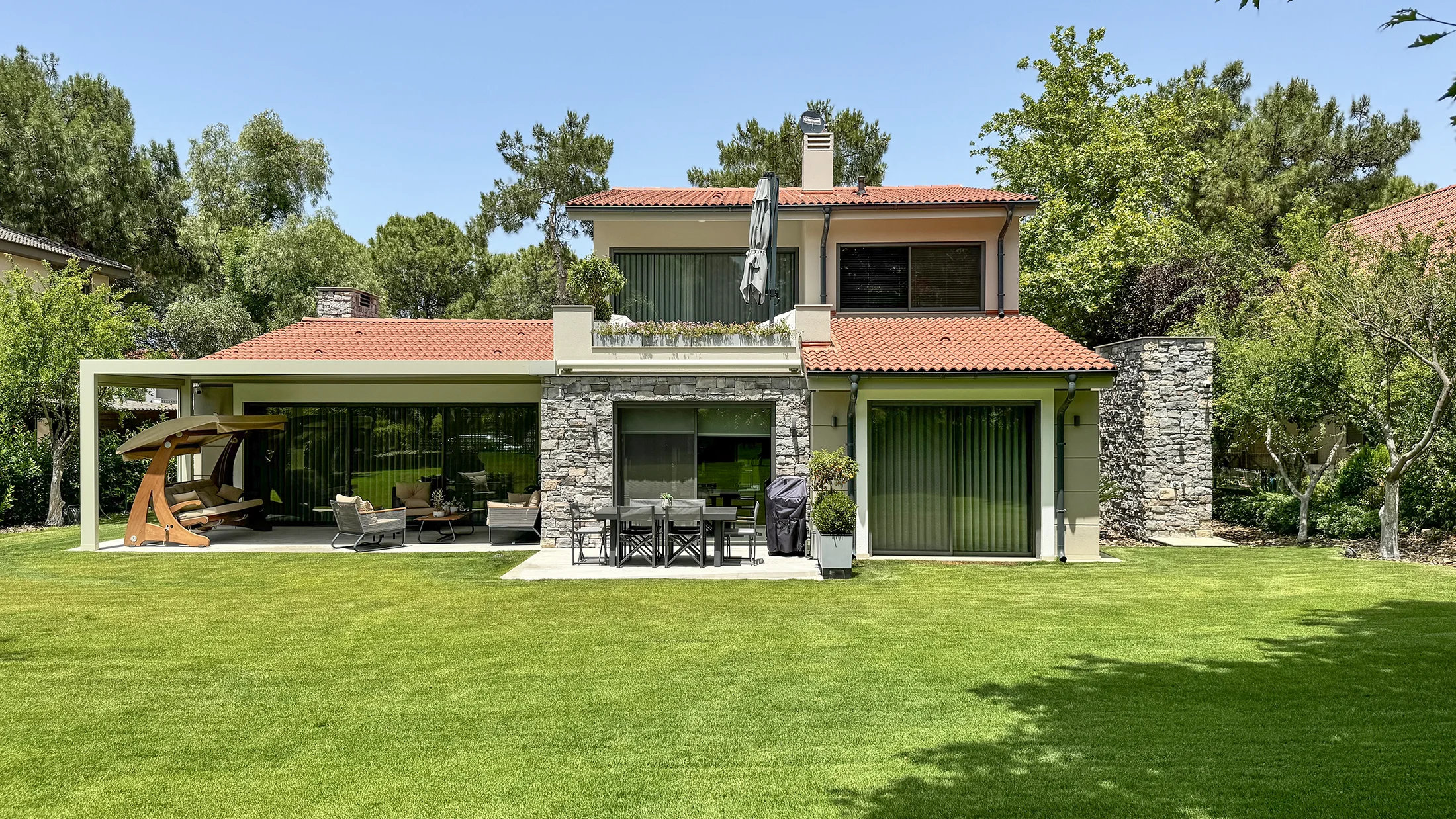 A spectacular house in a forest with stone veneer on exterior walls